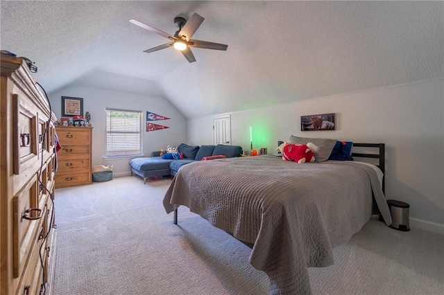 bedroom with light carpet, vaulted ceiling, a textured ceiling, and baseboards