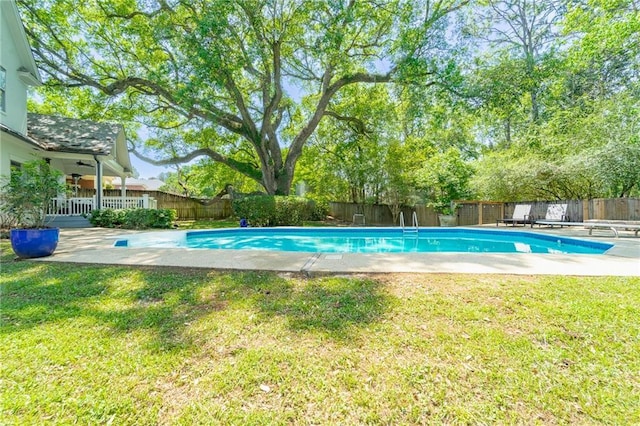 view of pool featuring a yard, a fenced backyard, a fenced in pool, and a patio area