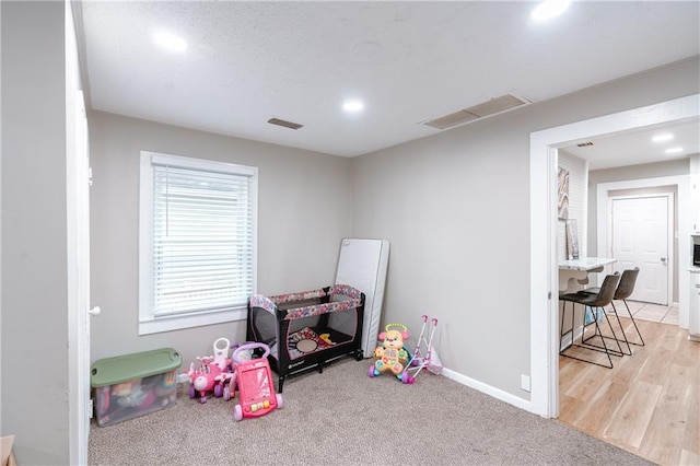 recreation room with light hardwood / wood-style flooring