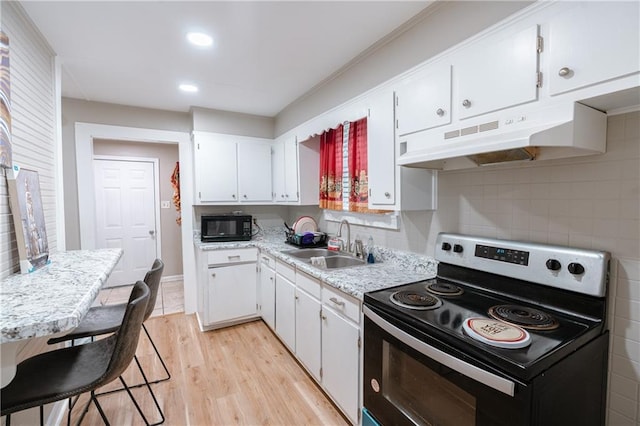 kitchen with white cabinets, light hardwood / wood-style flooring, black appliances, and sink