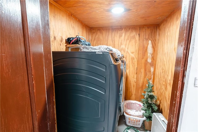 clothes washing area with wood walls and wooden ceiling