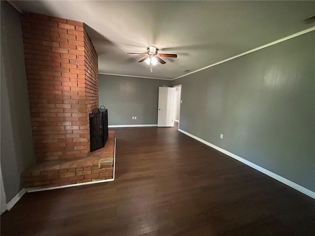 unfurnished living room featuring a wood stove, baseboards, a ceiling fan, and dark wood-style floors