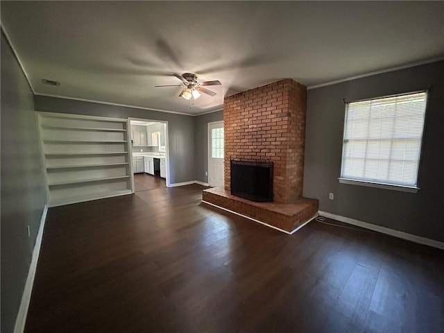 unfurnished living room with a fireplace, baseboards, dark wood-style floors, and a ceiling fan