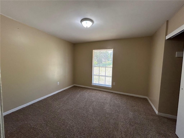 carpeted empty room with baseboards