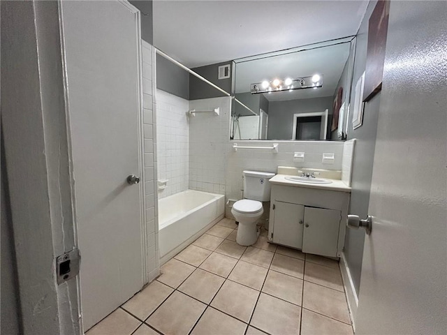 bathroom featuring toilet, bathing tub / shower combination, tile patterned flooring, and vanity