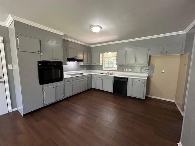 kitchen with black appliances, light countertops, under cabinet range hood, and dark wood-type flooring