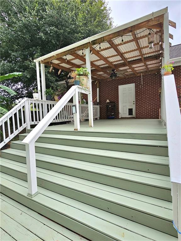 wooden terrace featuring ceiling fan