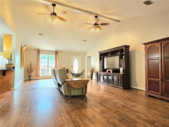 living room featuring ceiling fan, a textured ceiling, lofted ceiling with beams, and hardwood / wood-style floors