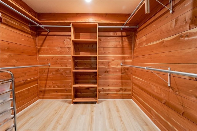 walk in closet with wood-type flooring