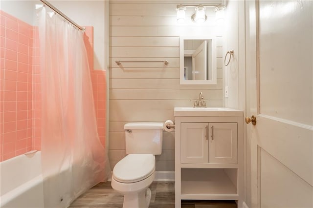 full bathroom with wood-type flooring, vanity, toilet, and shower / bath combo with shower curtain