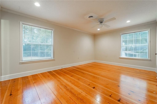 empty room with ceiling fan, wood-type flooring, and ornamental molding