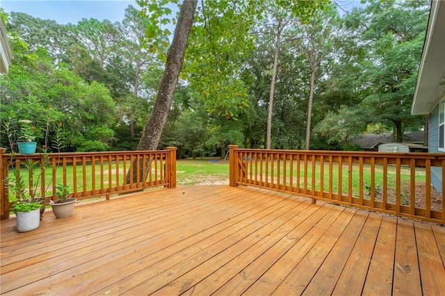 wooden terrace with a lawn