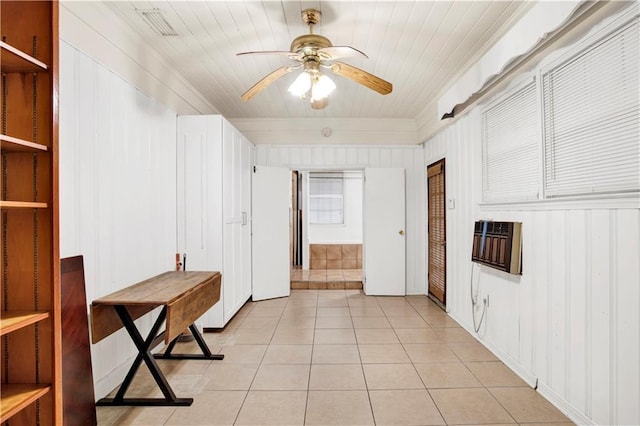 interior space with heating unit and light tile patterned flooring