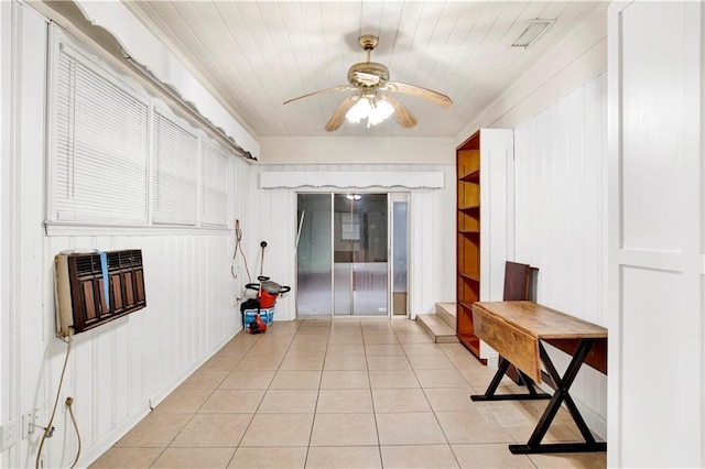 interior space featuring light tile patterned flooring and heating unit