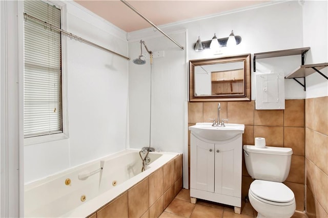 full bathroom featuring tile patterned floors, toilet, tile walls, vanity, and tiled shower / bath combo