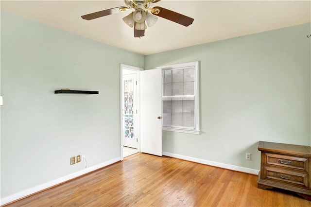 empty room featuring ceiling fan and light hardwood / wood-style floors