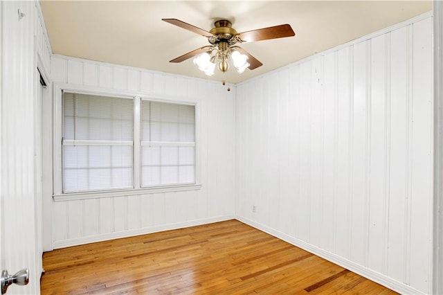 spare room with hardwood / wood-style floors and ceiling fan