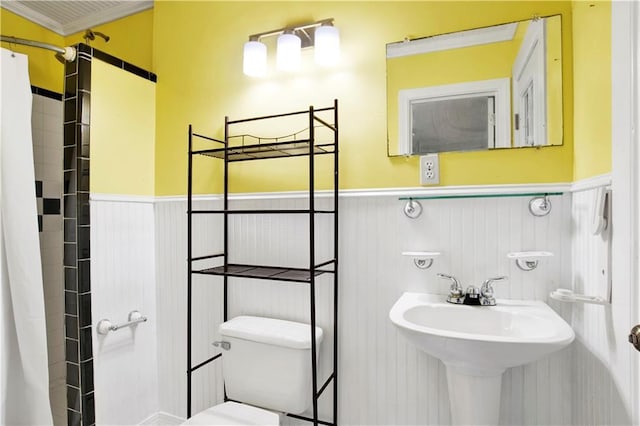 bathroom with crown molding, toilet, and sink