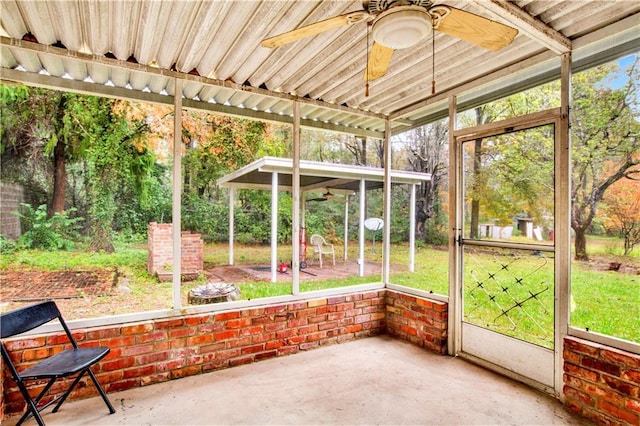 unfurnished sunroom featuring ceiling fan and a wealth of natural light