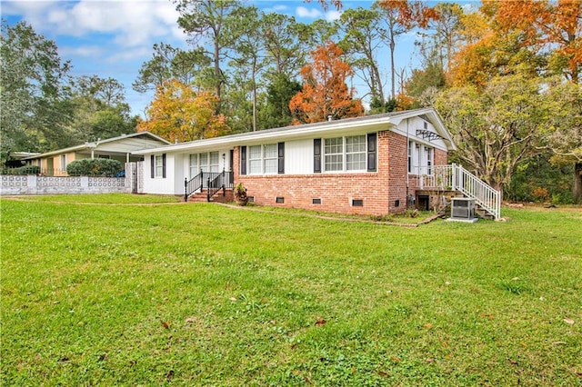 ranch-style house featuring cooling unit and a front yard