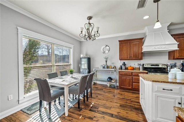 dining room with crown molding, an inviting chandelier, and dark wood-type flooring