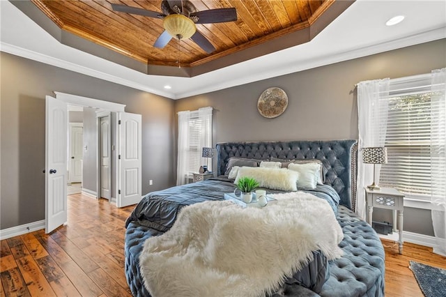 bedroom featuring crown molding, a tray ceiling, wood-type flooring, and wooden ceiling