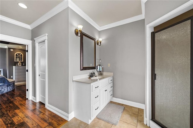 bathroom with crown molding, vanity, an enclosed shower, and tile patterned flooring