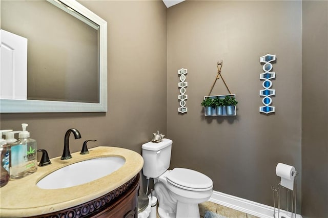 bathroom featuring vanity, tile patterned floors, and toilet