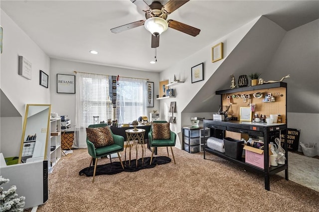 living area featuring carpet and ceiling fan