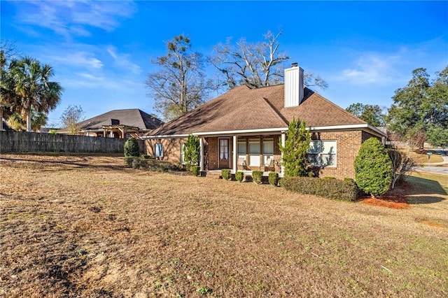 rear view of property with a yard