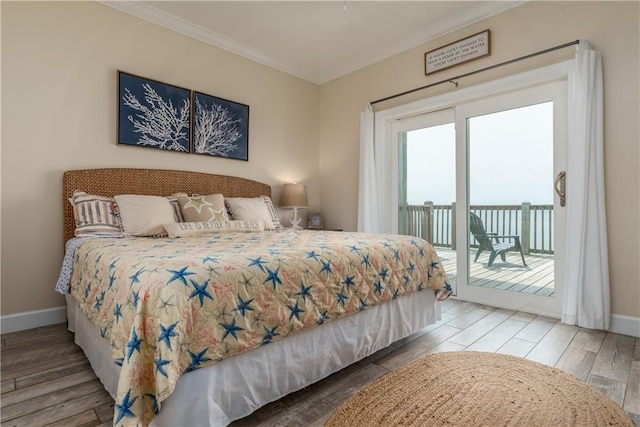 bedroom featuring crown molding, hardwood / wood-style floors, and access to outside