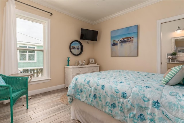 bedroom with ornamental molding and light hardwood / wood-style floors