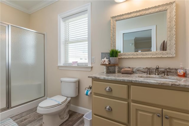 bathroom with hardwood / wood-style flooring, vanity, an enclosed shower, toilet, and crown molding