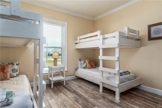 bedroom with ornamental molding and wood-type flooring