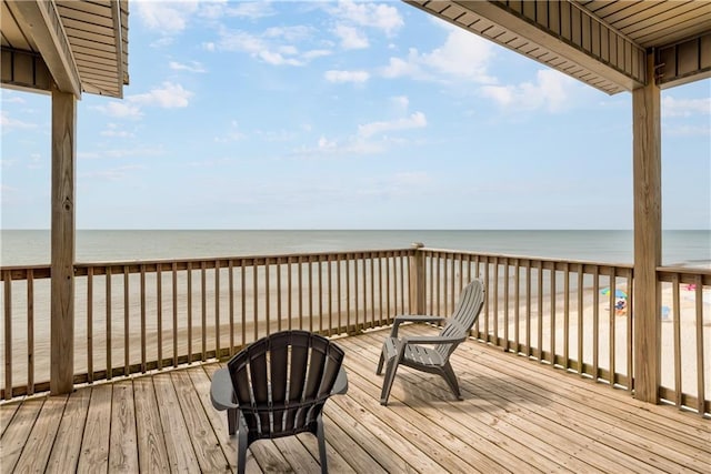 deck with a beach view and a water view