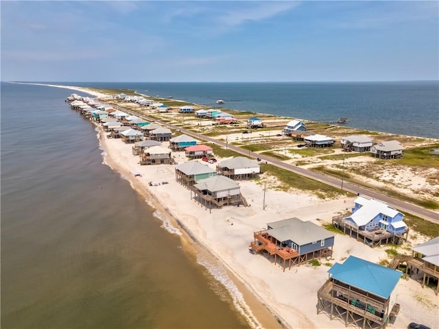 drone / aerial view featuring a water view and a beach view