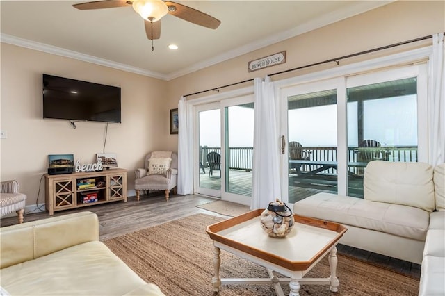 living room with crown molding, hardwood / wood-style floors, and ceiling fan