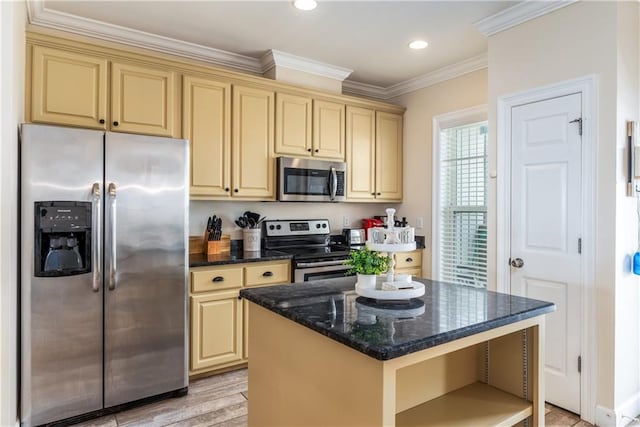 kitchen featuring crown molding, light hardwood / wood-style flooring, dark stone counters, a kitchen island, and stainless steel appliances