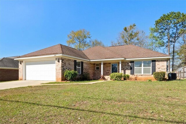 single story home with brick siding, an attached garage, a front lawn, central AC unit, and driveway