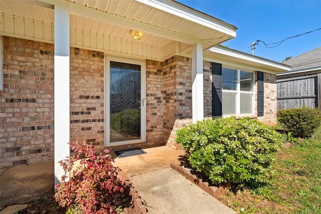 property entrance featuring brick siding