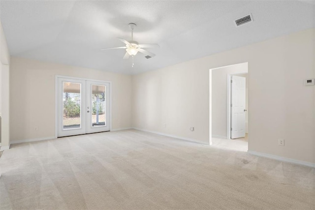 unfurnished room with visible vents, ceiling fan, lofted ceiling, light carpet, and french doors