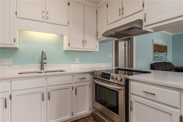 528 Lemoyne Dr Unit 2C, Dauphin Island, AL 36528 - kitchen with stainless steel electric range oven, under cabinet range hood, light countertops, white cabinetry, and ornamental molding