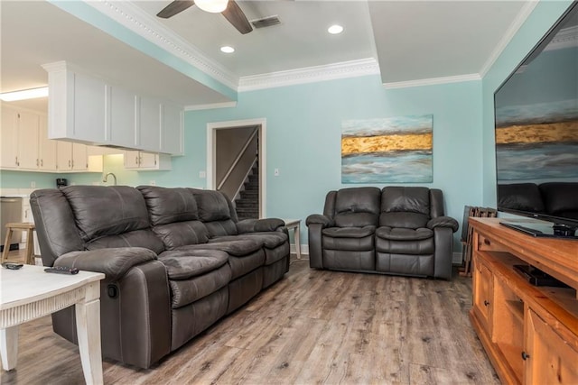 528 Lemoyne Dr Unit 2C, Dauphin Island, AL 36528 - living room with crown molding, light wood finished floors, a ceiling fan, recessed lighting, and stairs