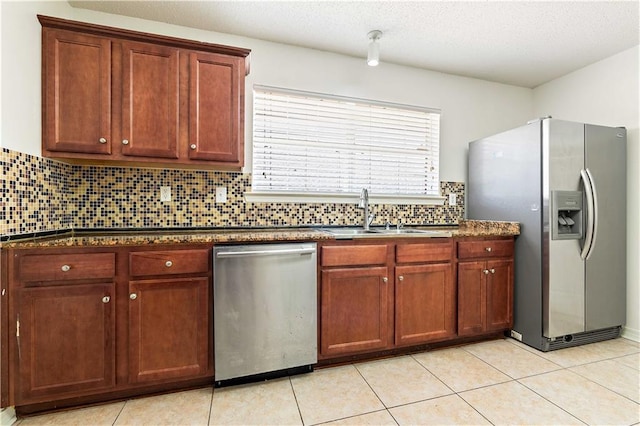 kitchen featuring sink, stainless steel appliances, backsplash, a textured ceiling, and light tile patterned flooring