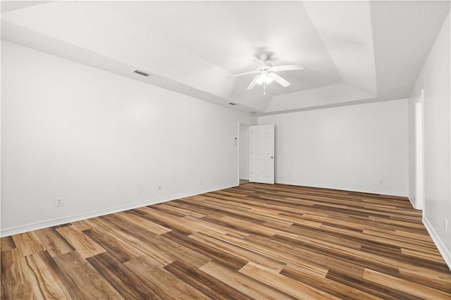 empty room featuring hardwood / wood-style floors and ceiling fan