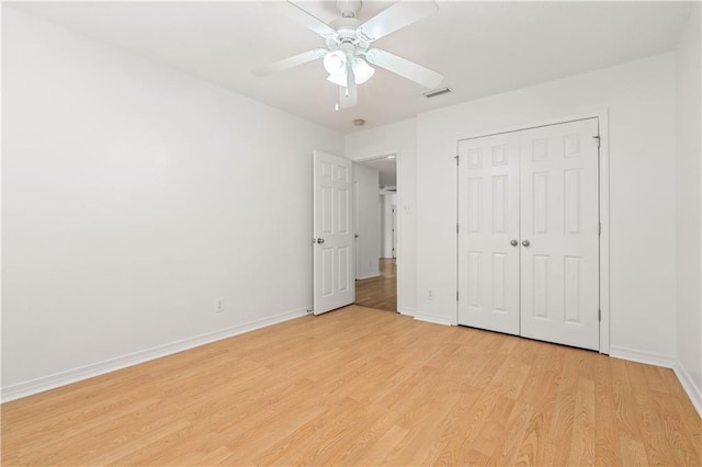 unfurnished bedroom with ceiling fan, light hardwood / wood-style floors, and a closet