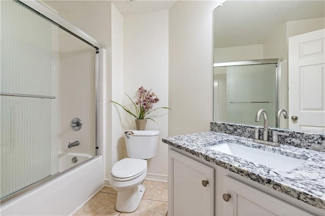 full bathroom with toilet, tile patterned flooring, vanity, and combined bath / shower with glass door