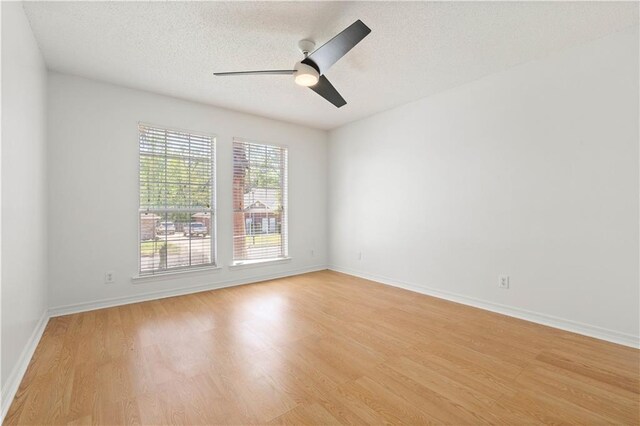 unfurnished room featuring ceiling fan, a textured ceiling, and light wood-type flooring