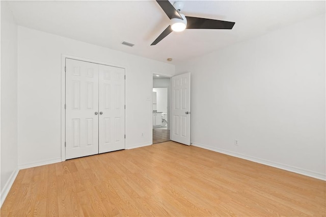 unfurnished bedroom with ceiling fan, a closet, and light hardwood / wood-style floors