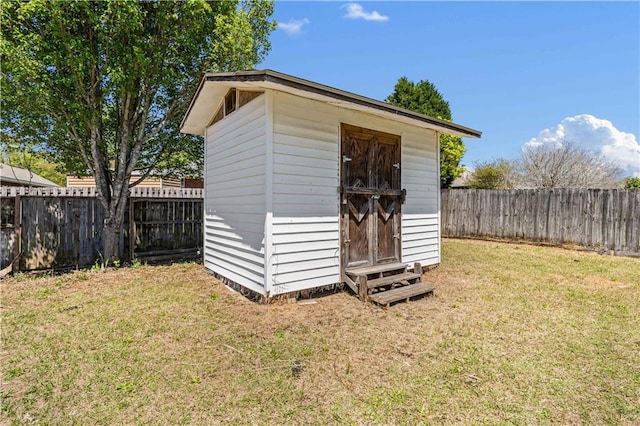 view of outdoor structure featuring a lawn